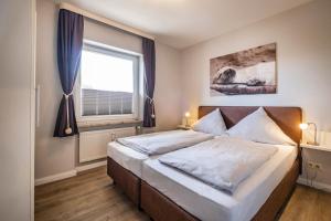 Postel nebo postele na pokoji v ubytování Haus Nordseeblick Wohnung 3