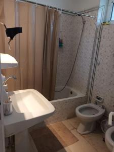 a bathroom with a shower and a toilet and a sink at VOULIAGMENI RIVIERA center between Beach and Lake in Athens