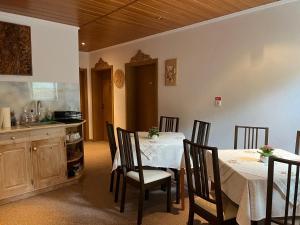a kitchen and dining room with a table and chairs at Casa Dan in Sovata
