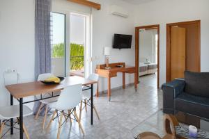 a living room with a table and a couch at Elli's apartment 2 in Antimácheia