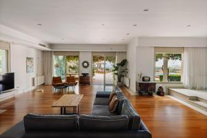 a living room with a couch and a table at Bello Blu Estate Luxury Mediterranean Villa in Asgourou