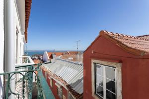 a view from a balcony of a red building at Vila Santa Marinha in Lisbon