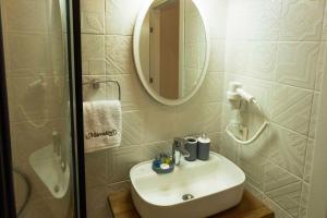 a bathroom with a white sink and a mirror at Marrakesh Alaçatı in Ildır +39 photos