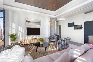 a living room with a couch and a table at Kalkbay Harbour Retreat in Cape Town