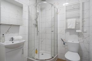 a bathroom with a shower and a toilet and a sink at RentPlanet - Studio Żeromskiego in Wrocław