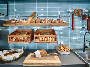 a bakery with baskets of bread and loaves of bread at Bio-Hotel Helvetia in Bad Schandau
