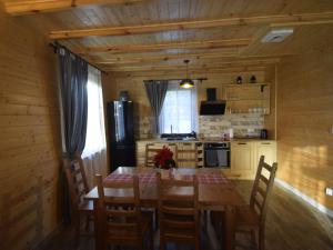a kitchen with a table and chairs in a room at Wooden Holiday Home in Skrzynia with Terrace in Osiek