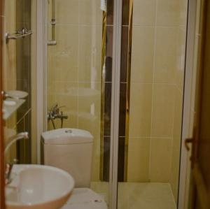 a bathroom with a shower and a toilet and a sink at Meriç butik otel 