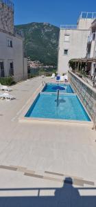 a swimming pool in the middle of a building at Aksioma Kotor in Kotor