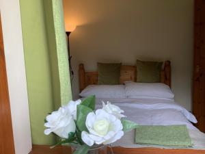 a bedroom with a bed with white flowers on it at Ty Twt - complete holiday home in Llandysul