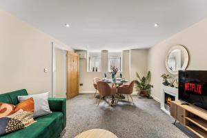 a living room with a green couch and a table at Stunning Church Conversion Apartment in Sheffield