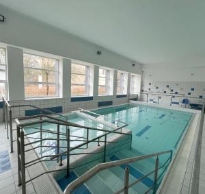 a large swimming pool with a glass floor at Kompleks Hotelowo-Rekreacyjny “Kasztelanka” in Ciechocinek