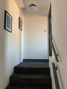 a staircase in a room with a stair case at Torpoint Pod - Free Parking in Torpoint