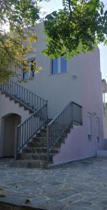 a building with a staircase on the side of it at Euphoria Estate in Agia Marina Aegina