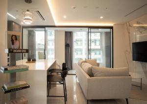 a living room with a white couch and a table at UH FLAT The Seocho in Seoul