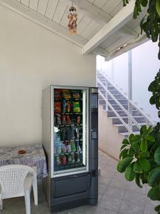 a refrigerator filled with drinks next to a table at VILLA AGIA AIKATERINI in Amoudi