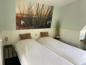 Postel nebo postele na pokoji v ubytování Hotelhuisjes Oosterleek
