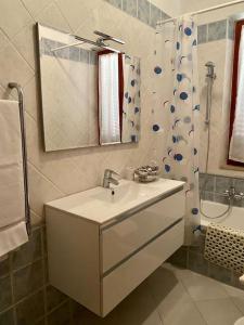 a white bathroom with a sink and a shower at Casa Lucietta, 30 mt dal mare e posto auto privato in Marciana Marina +16 photos