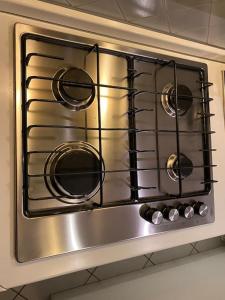 a stainless steel stove top oven in a kitchen at Casa Lucietta, 30 mt dal mare e posto auto privato in Marciana Marina