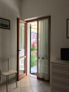 a room with a sliding glass door to a patio at Casa Lucietta, 30 mt dal mare e posto auto privato in Marciana Marina