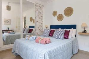 two beds with hello kitty pillows on them in a bedroom at Caleta del Sol con piscina terraza y playa in Caleta De Velez