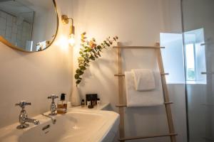 a bathroom with a sink and a mirror at Cathedral House in Glasgow