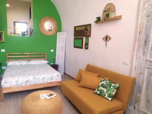 a bedroom with a bed and a couch at La casetta di Carmela in Naples