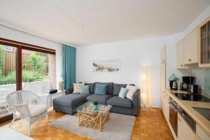 uma sala de estar com um sofá e uma mesa em Appartementhaus-Han-134 em Scharbeutz