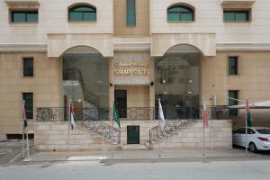 a building with flags in front of a store at Safari Hotel Apartment (Formerly Ewa Safari) in Jeddah