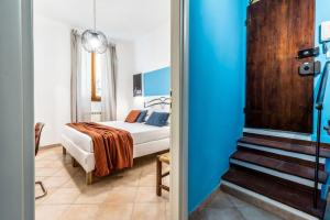 una piccola camera con letto e parete blu di Cielo di Siena - 200 metri da Piazza del Campo a Siena