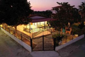 an aerial view of a house with a fence at Karipidis houses in Nea Iraklia