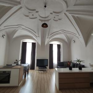 a large living room with a coffered ceiling and a couch at Apartman u Klavdie in Banská Bystrica