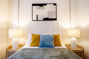 a bedroom with a bed with two lamps at Chic Flat 5 min to Galata Tower in Istiklal Ave in Istanbul
