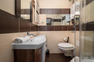 a small bathroom with a sink and a toilet at Market Square Corner Apartment Kuźnicza by Renters in Wrocław