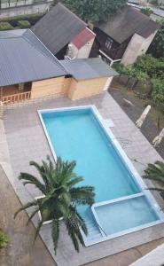 an overhead view of a swimming pool with a palm tree at Medea Kvariati in Kvariati