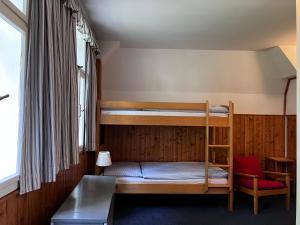 a bedroom with bunk beds and a table and a chair at Penzion Hají in Janov nad Nisou