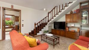 a living room with two chairs and a television at VILLA IRENE 6, Emma Villas in Montecarlo