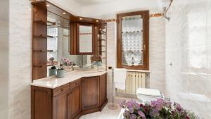 a bathroom with a sink and a shower and a tub at VILLA IRENE 6, Emma Villas in Montecarlo +35 photos