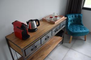 einen Tisch mit Kaffeemaschine und Stuhl in der Unterkunft Ici et Là - Chambres d'hôtes in Velleron