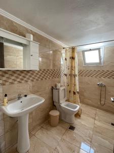 a bathroom with a sink and a toilet at Avdikos House in Parga