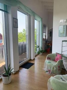 a living room with a large sliding glass door at Wohlfühloase auf 133-160qm in der Idylle an der Nahe in Duchroth