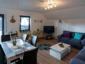 a living room with a table and a couch at Casa Mosella in Riol