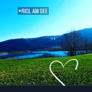 a heart in a field with a lake in the background at Casa Mosella in Riol