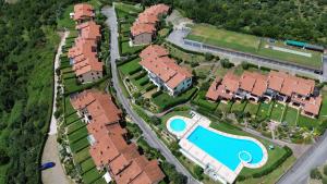 an aerial view of a house with a swimming pool at BBQ & Pools GHH in Toscolano Maderno