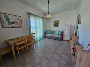 a living room with a table and a couch at Corfu Glyfada Menigos Resort 149 in Glyfada