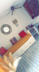 Zimmer mit einem Bett und einer Uhr an der Wand in der Unterkunft Le paradis du cap in Cap d'Agde