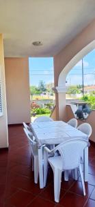 a white table and chairs in a room at Casa Fiore Olbia in Olbia
