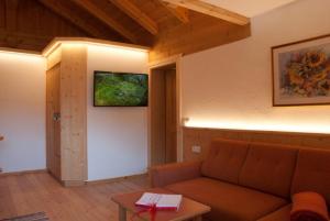 a living room with a couch and a table at Maurerhof in Racines