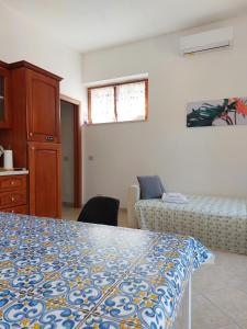 a bedroom with a bed and a couch in it at casa delle margherite Ladispoli in Ladispoli