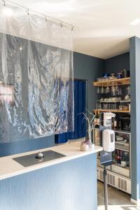 a kitchen with a white counter and a blue wall at Atami-view Resort in Atami